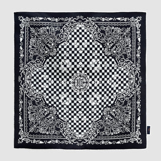 Black and white silk scarf with baroque pattern featuring ornate borders and a central checkerboard design with floral accents. Hand-rolled edges.
