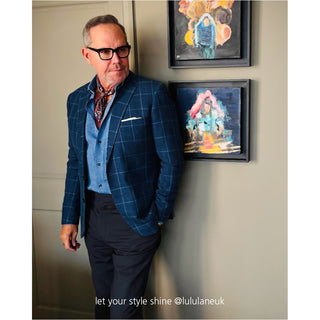 Plum purple geometric silk neckerchief styled with blue checkered suit and vest, showcasing versatile elegant look for modern men's fashion