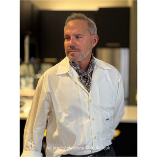 Ink blue Gothic Rose silk scarf styled as a neckerchief with mustard yellow edges, worn with a crisp white button-up shirt