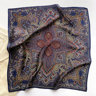Navy blue silk neckerchief with intricate burgundy and gold paisley pattern, displayed flat to showcase detailed boho design and luxurious texture
