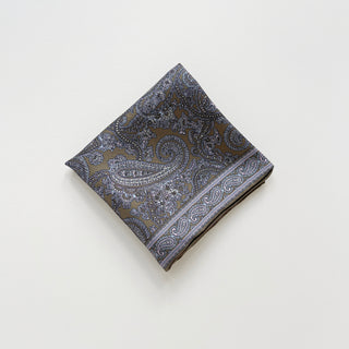 Folded taupe silk neckerchief for men featuring paisley pattern on a light grey background