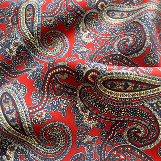 Close-up of red paisley silk neckerchief showing smooth twill texture.
