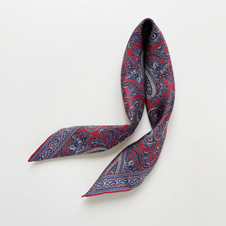 Men’s silk neckerchief scarf in red and navy paisley pattern, double-sided with hand-rolled edges.