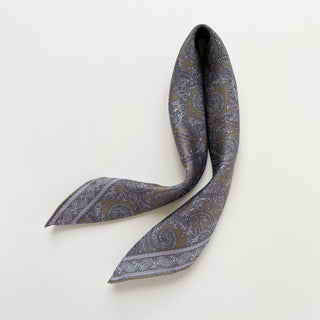Men's silk neckerchief in taupe featuring paisley pattern on a light grey background