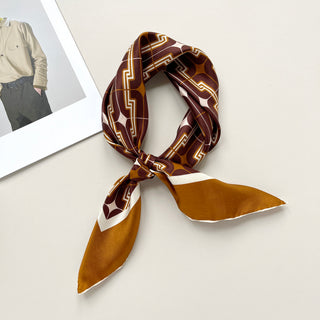Vintage-style silk neckerchief with burgundy, amber, and cream geometric patterns, featuring hand-rolled edges and retro 70s design