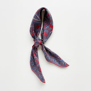 Men’s silk neckerchief scarf in red and navy paisley pattern, double-sided with hand-rolled edges.
