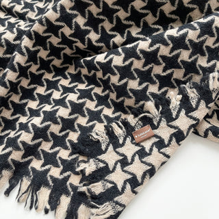 Close-up of a black and beige pure cashmere scarf with houndstooth check pattern and LuluLane label