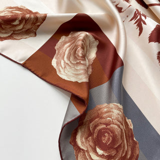 Close-up of Berlin Rose silk scarf – 65cm vintage floral square bandana in sepia tones with rust red hand-rolled hems by LuluLane
