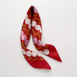 Geometric mid-century silk scarf by LuluLane with Bauhaus-inspired design in red, pink and brown tones.