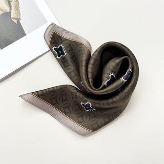 Olive green silk neckerchief with geometric pattern, featuring shining star motifs with blue accents and elegant gray border, displayed with soft folds on white surface.