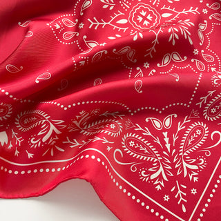 Close-up of a unisex red silk square scarf with double-sided bandana print, 100% silk twill by LuluLane.