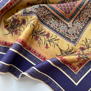 Indigo Royal silk scarf with vintage floral pattern, featuring gold center with red blooms, geometric borders, and ornate corner designs