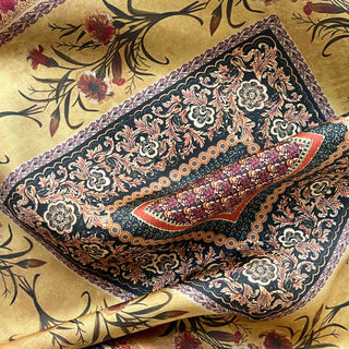 Indigo silk scarf with intricate vintage floral patterns featuring ornate borders in gold, red, and cream on a luxurious golden background with delicate blooms.