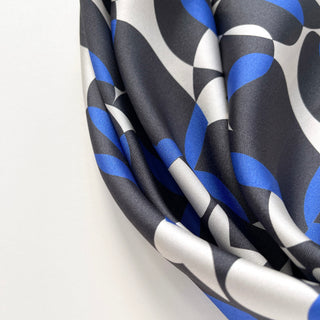 Close-up of women’s silk scarf 90cm in pebble-inspired print, English seaside tones, large square with hand-rolled hems by LuluLane.