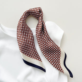 Red and white silk scarf with modern lattice pattern, navy blue border, styled as neckerchief on white collar, 53cm unisex bandana