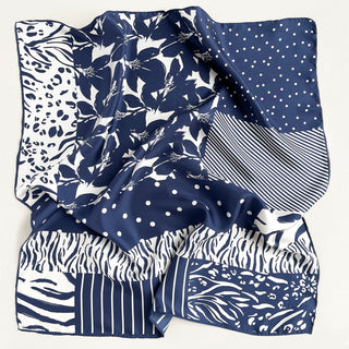 Navy and white silk square scarf featuring mixed patterns including floral, leopard print, polka dots and stripes with hand-rolled edges