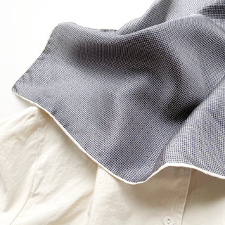 Black and white silk scarf with classic grid and polka dot pattern, featuring hand-rolled edges and a luxurious silky texture