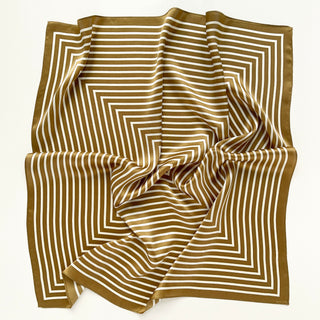 Luxurious brown and white silk bandana scarf with concentric square pattern, elegantly draped to showcase its shimmering texture and geometric design.