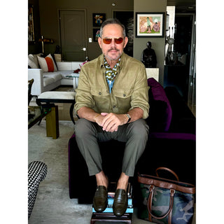 Man wearing retro geometric pattern silk neckerchief scarf with green khaki jacker style shirt – men’s square silk scarf.