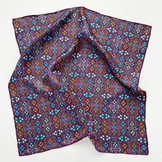 Plum purple silk neckerchief with intricate geometric pattern featuring blue, orange, and turquoise designs with hand-rolled edges