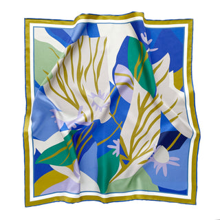 Square silk scarf with abstract lotus design featuring vibrant blue, green, lilac, and mustard yellow patterns with hand-rolled edges