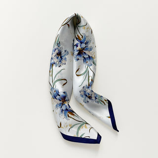 women's silk scarf with blue bell floral pattern on white background, bordered with navy blue edges