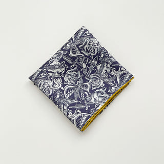 Folded Retro rose silk scarf neckerchief in navy blue and ivory with vintage floral and swallow print and mustard yellow hand-rolled edges