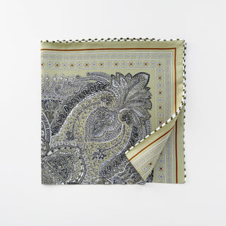 Square silk scarf in matcha green with intricate paisley pattern, featuring black and white detailed designs and checkered hand-rolled edges