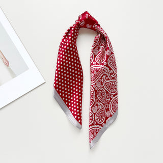 Red silk bandana scarf with dual pattern design - polka dots on left side, paisley print on right, with silver border trim on a white background