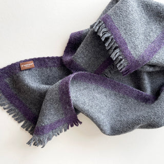 Heather grey cashmere scarf with a purple contrast border, fringed ends and a LuluLane® label.