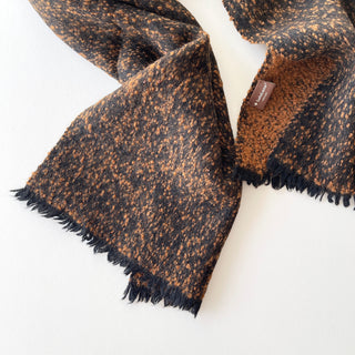 Black and warm brown cashmere scarf with short black fringes and a LuluLane® label.