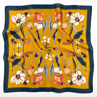 Mustard yellow silk square scarf with navy border featuring symmetrical floral pattern of white, pink, and coral blooms with monarch butterflies and delicate stems