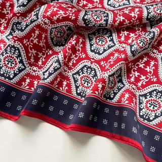 Luxurious red and navy silk scarf with intricate floral geometric pattern, featuring decorative borders and elegant hexagonal designs