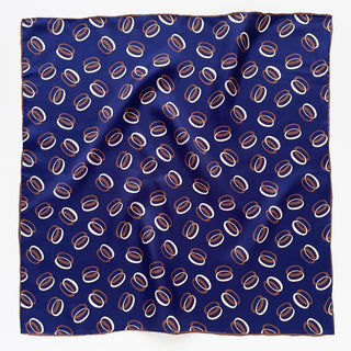 Indigo purple silk scarf with repeating copper and white orbit pattern, featuring hand-rolled edges and lustrous silk twill texture