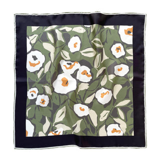 Forest green silk scarf with white floral print and orange accents, featuring hand-rolled edges and navy border, displayed flat