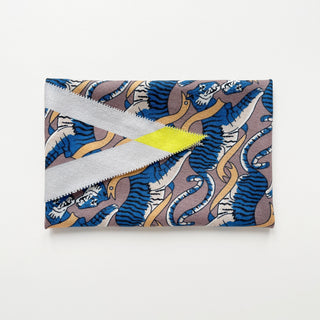 Diamond-shaped cashmere silk scarf with blue tiger pattern on mauve background, featuring gold accents and striking yellow detail on light grey trim