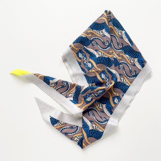 Diamond-shaped cashmere silk scarf with blue tiger pattern, mauve background, gold accents, white border, and bright yellow corner detail