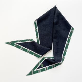 Diamond-shaped black cashmere silk scarf with green plaid border and white accent stripes, displayed on white background