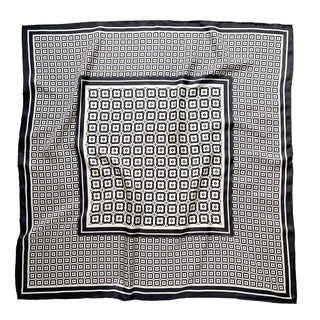 Elegant 90cm silk scarf featuring black and white geometric floral pattern with hand-rolled edges, displayed flat to showcase its luxurious design
