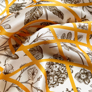 Luxurious yellow baroque silk scarf featuring intricate botanical sketches and golden ribbon pattern on ivory backdrop, showcasing detailed floral illustrations