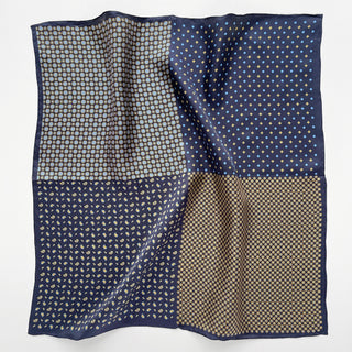 Navy blue silk pocket square with four distinct geometric patterns, featuring hand-rolled edges and classic motifs in gold, light blue, and cream tones
