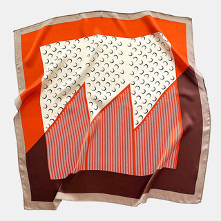 Square silk scarf with Lunar Peaks design featuring tangerine orange, cream, blue, and brown geometric pattern with mountain motifs and crescent shapes