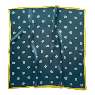 Square silk scarf with teal green background, light blue polka dots pattern, and bright yellow border, displayed flat to show elegant design