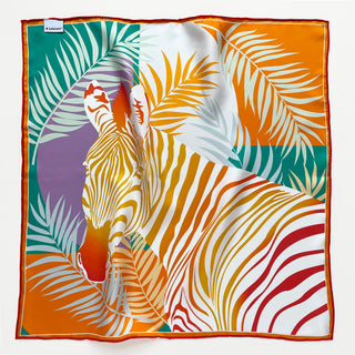 Luxury silk scarf featuring vibrant zebra print with orange, red, and white stripes against tropical palm leaves on teal, purple, and orange background