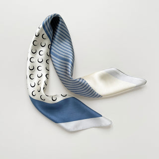 Lunar Peaks silk scarf featuring French blue color with white zigzag pattern, crescent moon design on white background, and solid blue accents
