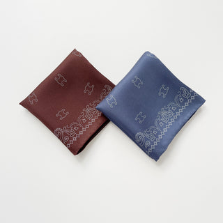 Two silk neckerchiefs with paisley patterns - one in Indian Red and one in Dusty Blue, both featuring MARVEL logo in dotted design