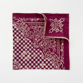 Burgundy baroque silk scarf with cream hand-rolled edges, featuring checkered pattern and ornate paisley design, folded to display luxury texture