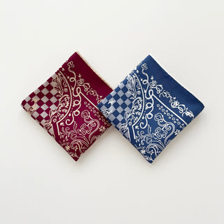 Two folded silk scarves with baroque check pattern - burgundy and steel blue colors featuring ornate white designs and checkerboard borders on pure silk twill