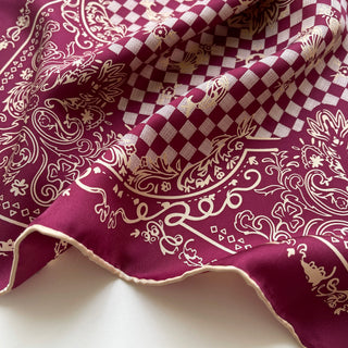 Luxury burgundy silk scarf with cream baroque pattern and checkered design, featuring hand-rolled edges and elegant draping texture