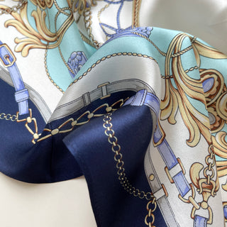 Turquoise & Navy Baroque Bridle silk scarf with equestrian design featuring gold chains, blue buckles, and ornate floral motifs on luxurious silk fabric